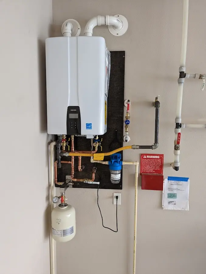 Professional plumber installing copper piping in a Oyster Bay home